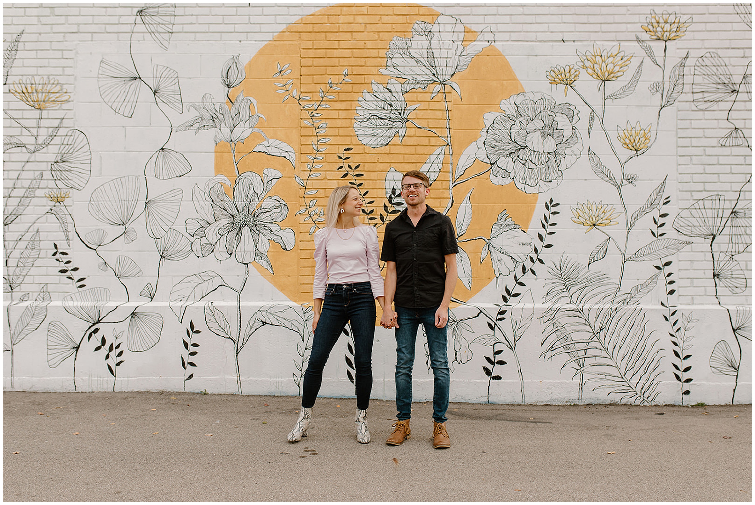 couple standing in front of wall