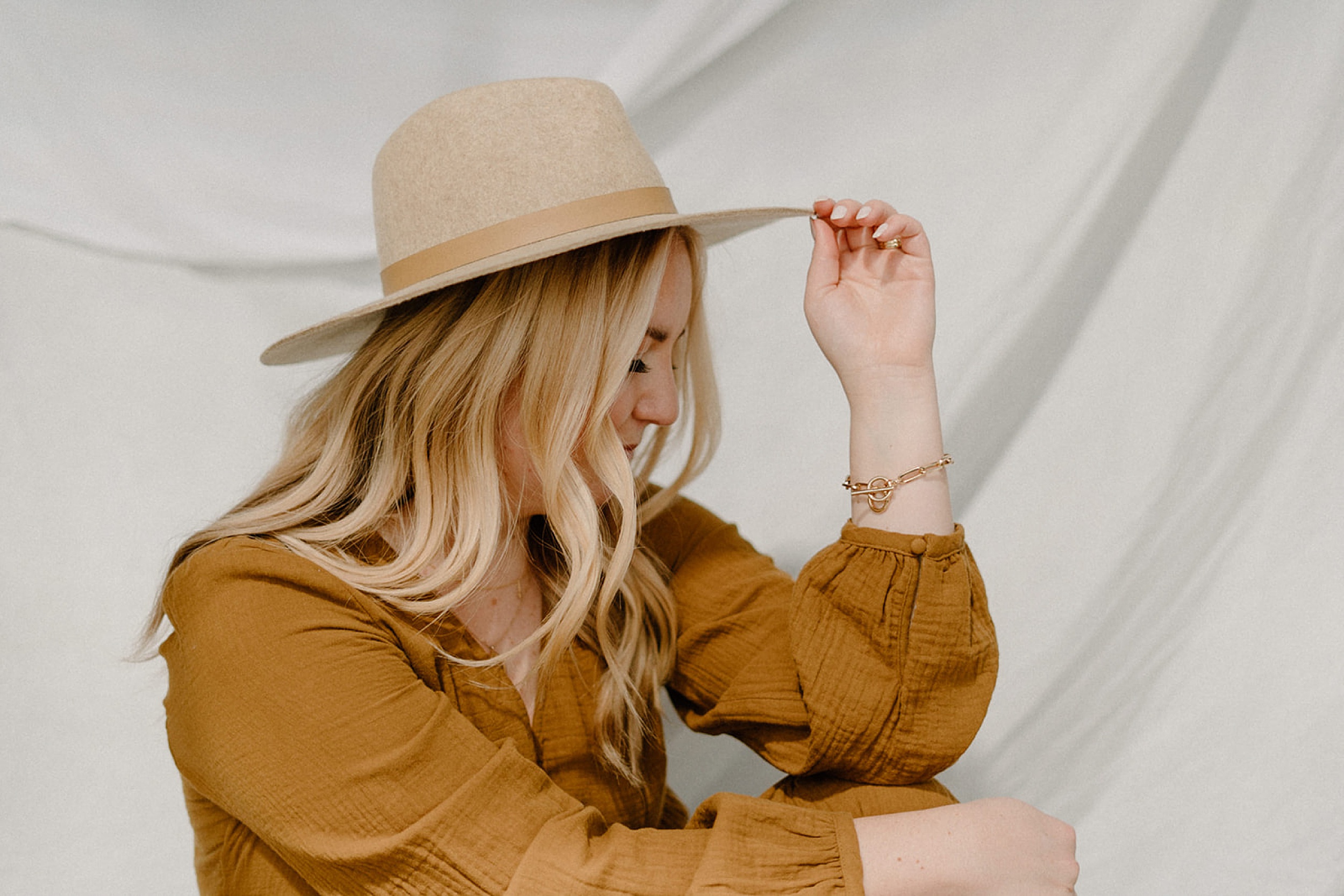 girl holding hat